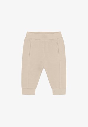Pantalon de jogging beige en tissu doux avec une ceinture élastique, des poches latérales et des poignets resserrés à la cheville.