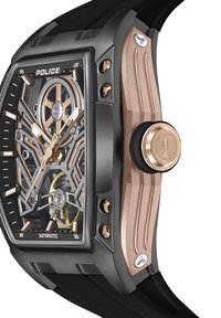 Črno in rožnato zlata samodejna ura s pravokotno ohišjem, prozornim številčnikom, vidnimi zapletenimi zobniki in gumijastim trakom.