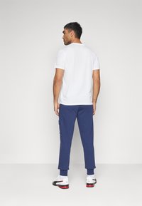 Puma CARGO PANTS - Pantalones deportivos - peacoat