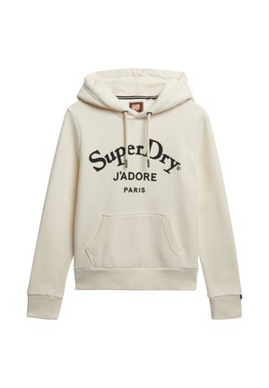 Hoodie color crema con capucha ajustable, bolsillo tipo canguro en la parte frontal y texto impreso en negro: "Super Dry J'ADORE PARIS." Acabado de tela suave.