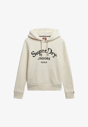 Hoodie color crema con capucha ajustable, bolsillo tipo canguro en la parte frontal y texto impreso en negro: "Super Dry J'ADORE PARIS." Acabado de tela suave.
