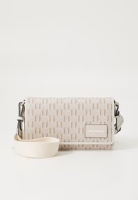 Crossbody bag made of patterned beige fabric. Features a detachable shoulder strap and a logo panel. Rectangular shape with a smooth texture.