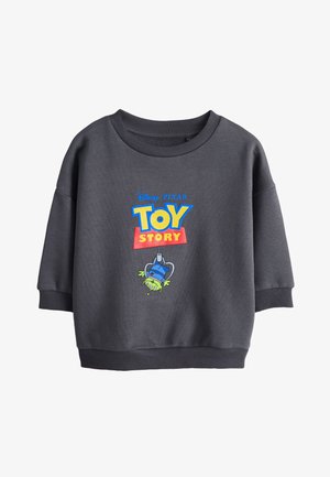 Felpa grigio scuro a maniche lunghe con logo Toy Story e un giocattolo alieno verde capovolto appeso a un'immagine di macchina afferra tutto.