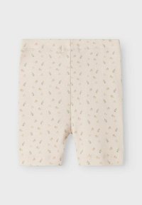 Jasnobeżowe spodenki rowerowe z teksturą prążkowaną, ozdobione kwiatowym wzorem w odcieniach różu i niebieskiego. Elastyczny pas i obszyte brzegi.