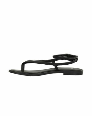 Black flat sandals with thin cross-over straps, open toe design, adjustable ankle strap, and flat rubber sole.