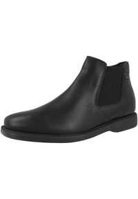 Botín Chelsea de cuero negro con paneles elásticos en los lados, punta redondeada y un acabado suave. Cuenta con una suela de goma baja y plana.