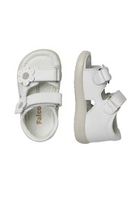 Weiße Ledersandalen mit zwei Klettverschlussriemen, einem Blumenakzent an der Vorderseite und einer strukturierten Sohle. Offenes Design, gepolsterter Innenraum.