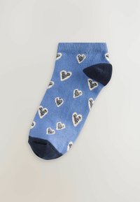 Calcetín azul hasta el tobillo con un patrón de corazones blancos y secciones de punta y talón en azul oscuro. Hecho de material suave y elástico para mayor comodidad.