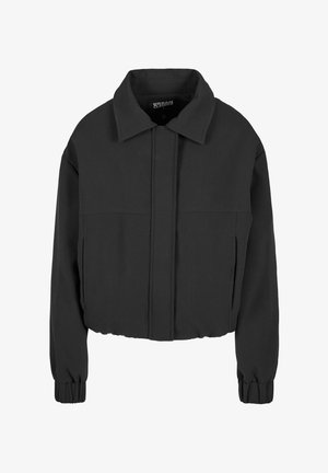 Fekete, rövidített dzseki sima anyagból, hegyes gallérral, hosszú ujjakkal, elasztikus mandzsettával, és elülső panel varrással.