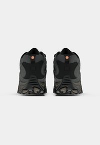 Gray hiking shoes with black accents, textured mesh upper, reinforced heel, and rugged traction sole. Features circular logo on heel tab.