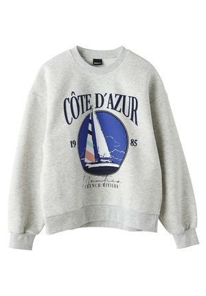 Sweat-shirt gris clair à poignets et bas côtelés, imprimé d’un voilier et des mots « Côte d’Azur » et « French Riviera ».