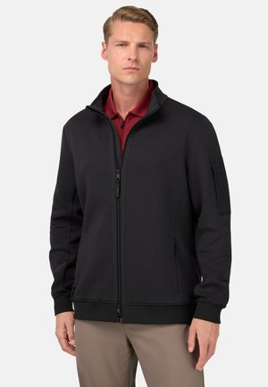 Black zip-up jacket with high collar, side pockets, and textured fabric. Features a fitted design and partial zipper closure.