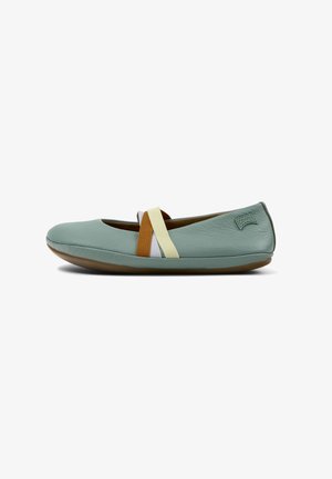 Light blue leather ballet flat with a flexible brown sole, featuring multicolored elastic straps across the vamp and a rounded toe.