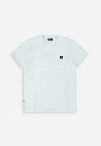 Light blue cotton t-shirt with a round neckline, short sleeves, and a small black logo patch on the chest. Smooth texture, straight hem.
