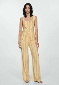 Yellow and cream-striped sleeveless top with a square neckline, paired with wide-leg pants in the same pattern. Smooth texture, casual fit.