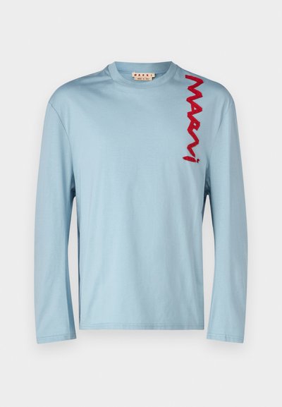 Light blue long-sleeve shirt made from soft cotton, featuring a red embroidered logo on the left side and a crew neckline.