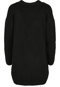 Black oversized sweater, made from a textured knit material, featuring wide sleeves and a rounded neckline, with a long, loose fit.