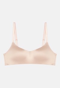 Bralette beige clair en tissu doux. Doté de bretelles réglables, d'un design sans couture et d'un rembourrage doux pour le confort.
