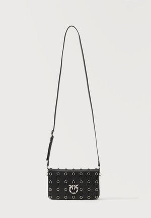 Black rectangular crossbody bag with silver eyelet details and a double bird silver clasp, hanging by a long adjustable strap.