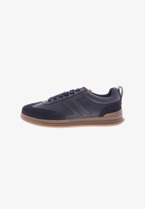 Navy sneaker with a smooth leather and suede upper, contrasting dark grey accents, lace-up design, and a gum rubber sole for traction.