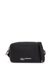 Black leather crossbody bag with white stitching. Features a zip closure and a silver logo on the front. Compact rectangular shape.