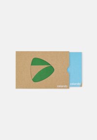 Kraft paper envelope with green cut-out design, blue card inside, and white "zalando" logo. Minimalistic and eco-friendly appearance.