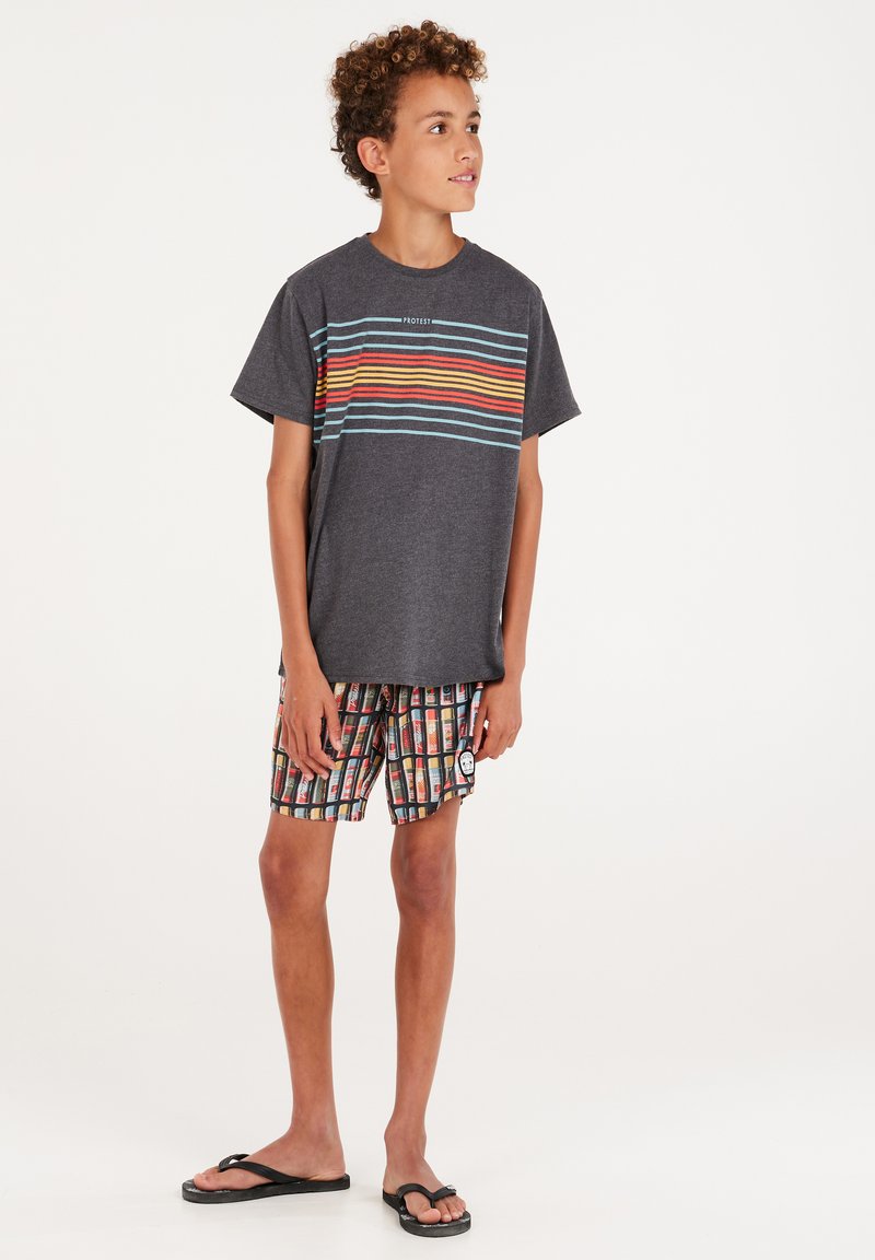 Grijze T-shirt met kleurrijke horizontale strepen; gestreepte zwembroek met veelkleurige rechthoekige ontwerpen; zwarte slippers.