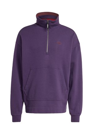Purple fleece pullover with a half-zip collar, front pocket, ribbed cuffs, and a logo emblem on the chest. Soft texture and relaxed fit.