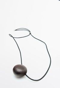 Black leather necklace featuring a smooth, oval-shaped pendant in dark brown. The cord is thin and adjustable for length.