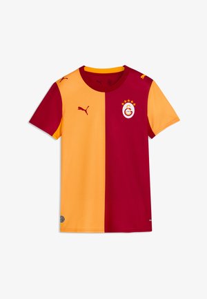 Koszulka piłkarska z krótkim rękawem, podzielona pionowo na żółtą lewą i czerwoną prawą stronę, z logo Puma i herbem drużyny Galatasaray z gwiazdkami.