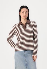 Long-sleeve polo shirt featuring brown and white horizontal stripes, with a solid brown collar and relaxed fit. Cotton material, smooth texture.