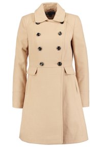 Abrigo beige de mujer de doble botonadura con botones negros, cuello de muesca, mangas largas, cinturón en la cintura y dos bolsillos con solapa.