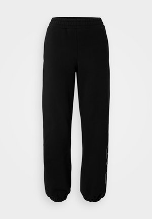 Pantalons de survêtement noirs avec un waistband élastique et des poignets. Fabriqués en tissu doux avec un détail de design subtil sur la jambe gauche.