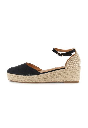 Espadrille compensée noire et beige avec bout fermé, bride à la cheville et semelle plateforme en jute tressé.