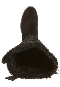 Bota negra de gamuza hasta la rodilla con forro de piel, puntera redondeada y tacón bajo. Vista interior que muestra una textura suave y un interior liso.