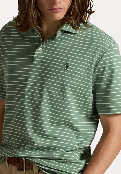 Camisa polo verde com riscas horizontais brancas, colarinho com fecho de dois botões e um pequeno logótipo bordado no lado esquerdo do peito.