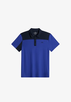 Sininen polo-paita mustilla yksityiskohdilla, jossa on kolme nappia napituksessa, lyhyet hihat ja logo vasemmassa rinnassa. Sileä, kevyt kangas.