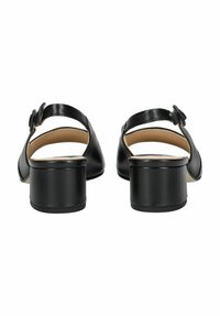 Sandales en cuir noir avec un dos fermé, une sangle de cheville et un talon carré arrondi. Notez la finition lisse et le détail matériel subtil.