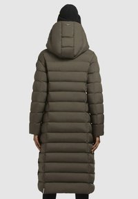 Long, olive green puffer coat with horizontal quilted sections, a large hood, and fitted sleeves. Black knit beanie visible on top.