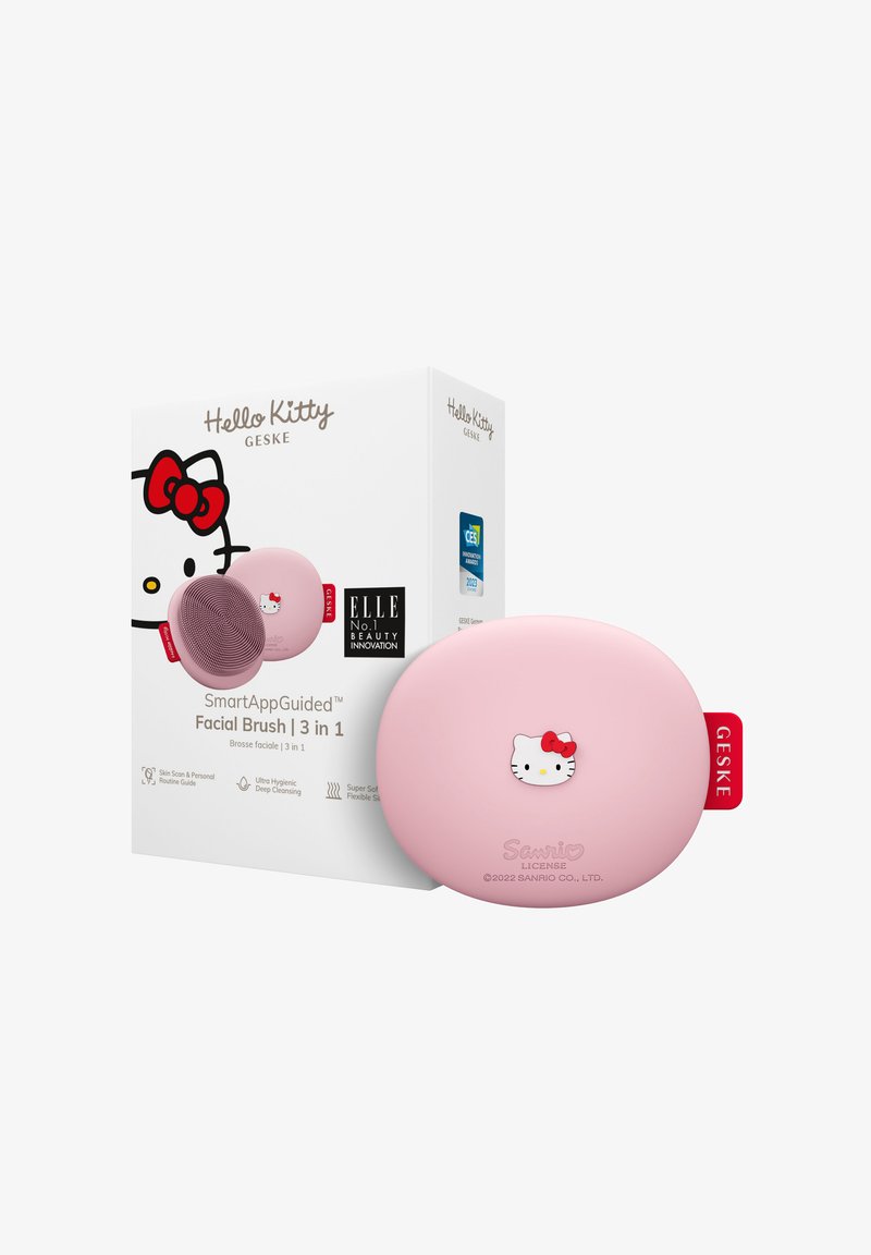 Hello Kitty gezichtsborstel in het roze met een zachte, ronde vorm en reliëfdetail van het karakter; inclusief een witte doos met merknamen en productinformatie.