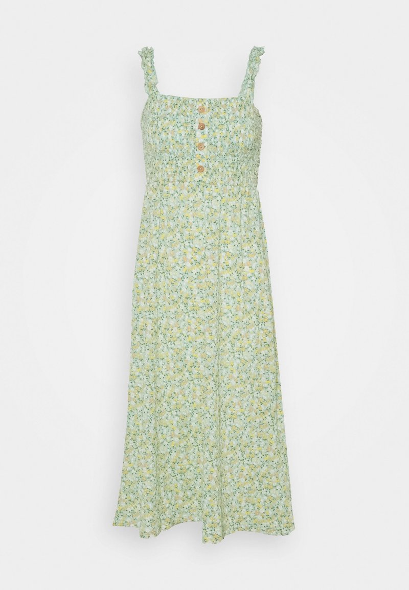 Robe maxi florale en vert clair avec des fleurs jaunes et blanches. Caractéristiques : bretelles froncées, corsage smocké et détail de bouton à l'avant.