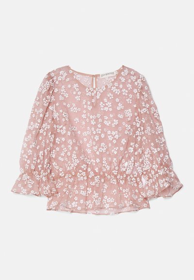 Pink sheer blouse with white floral patterns, round neckline, puff sleeves, and a gathered waist, featuring a back zip closure.