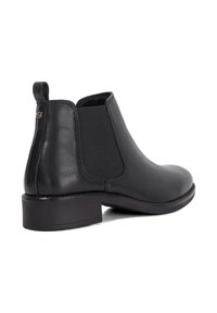 Black leather Chelsea boot with elastic side panels, low block heel, and minimalistic design. Smooth texture and sleek silhouette.