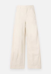 Calças largas em tecido de algodão bege, com bolsos frontais e uma textura suave. Sem embelezamentos ou padrões visíveis.