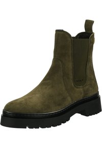 Olive green suede ankle boot with a rounded toe, elastic side panels, and a chunky black rubber sole featuring a treaded pattern.