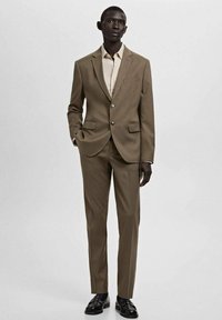 Brauner, maßgeschneiderter Anzug mit einreihigem Blazer, passenden Hosen und einem hellen Hemd. Glatte Textur, minimalistisches Design, dezente Akzente.