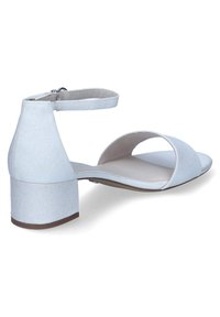 Light blue sandal with ankle strap, open toe design, and low block heel. Features sparkly texture and a smooth insole for comfort.