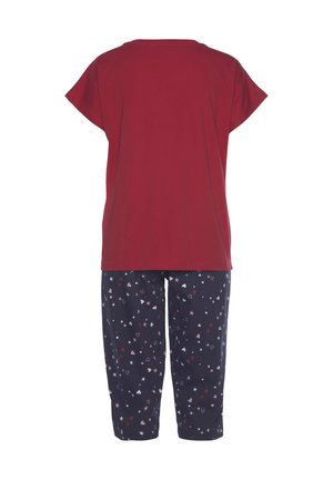 Red short-sleeve top with a round neckline paired with navy pants featuring a pattern of hearts and stars in pink and white.
