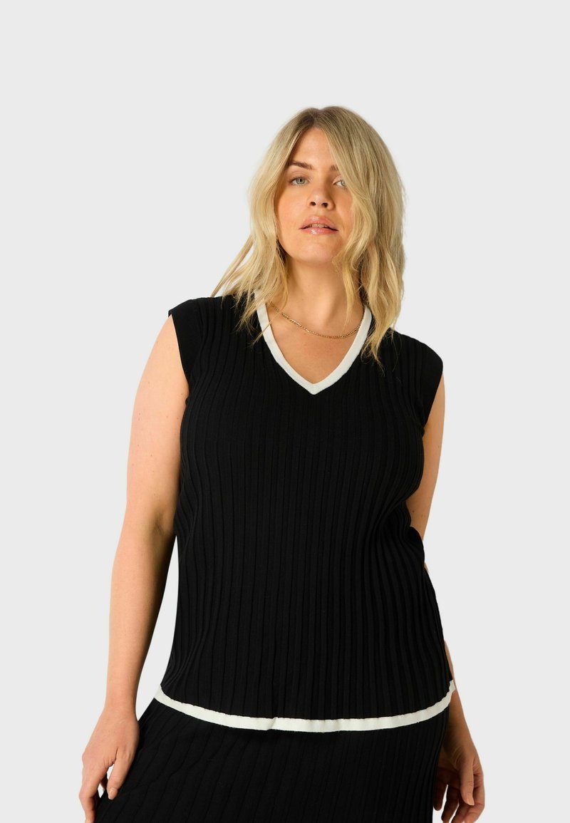 Černý žebrovaný top bez rukávů s výstřihem do V a bílým lemem kolem výstřihu a spodního okraje, s přiléhavým střihem a texturovanou tkaninou.