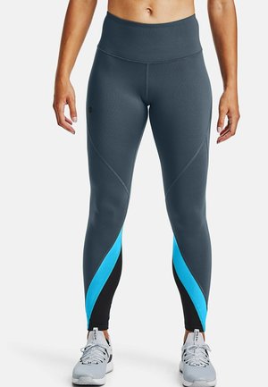 Leggings atletici grigi con vita alta, con pannelli laterali blu e neri e dettagli di cucitura sottili. Tessuto morbido e elasticizzato.